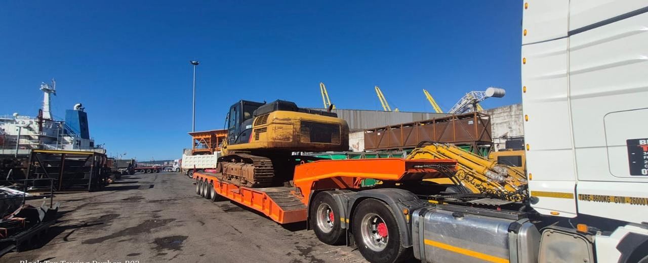 Excavator loaded on a trailer at Durban port
