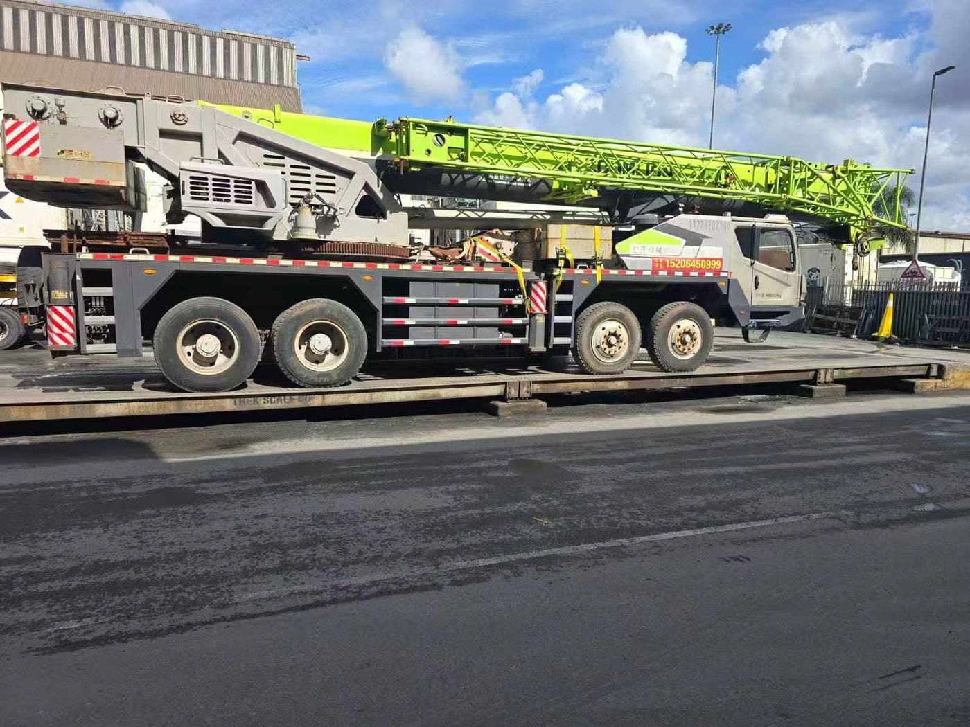 Truck-mounted crane secured on a trailer